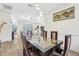 Dining room boasts a unique glass and wood table, pendant lights, and view into living area at 18026 Nutcracker Rd, Weeki Wachee, FL 34614