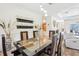 Inviting dining room with modern lighting, a unique table, and a view into the living area at 18026 Nutcracker Rd, Weeki Wachee, FL 34614