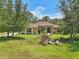 Beautiful single-story home with manicured lawn, mature trees and a welcoming facade at 18026 Nutcracker Rd, Weeki Wachee, FL 34614