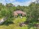 Beautiful single-story home with manicured lawn, mature trees and a welcoming facade at 18026 Nutcracker Rd, Weeki Wachee, FL 34614