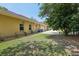 View of the house with a well-manicured lawn, featuring a patio, and tasteful landscaping along the side of the home at 18026 Nutcracker Rd, Weeki Wachee, FL 34614