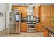 Well-equipped kitchen showcasing stainless steel appliances, including a smart refrigerator and gas range at 18026 Nutcracker Rd, Weeki Wachee, FL 34614