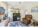 Comfortable living room with recliner, TV, nautical decorations, and neutral wall color at 18026 Nutcracker Rd, Weeki Wachee, FL 34614