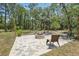 Inviting outdoor patio area complete with a stone fire pit and comfortable seating, ideal for relaxing or entertaining guests at 18026 Nutcracker Rd, Weeki Wachee, FL 34614