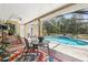 Covered lanai features a private pool with ample seating, perfect for outdoor entertaining at 18026 Nutcracker Rd, Weeki Wachee, FL 34614