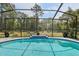 Sparkling pool, surrounded by a screened enclosure and lush greenery at 18026 Nutcracker Rd, Weeki Wachee, FL 34614