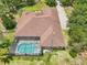 Aerial shot of a screened pool with crystal clear water adjacent to a beautiful single-Gathering home at 18026 Nutcracker Rd, Weeki Wachee, FL 34614