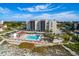 Aerial shot of a resort complex, highlighting the pool, beach access, and well-maintained surroundings at 2045 Gulf Of Mexico Dr # M1-207, Longboat Key, FL 34228