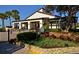 Charming clubhouse entrance with well-maintained landscaping, creating a welcoming atmosphere for residents and guests alike at 2045 Gulf Of Mexico Dr # M1-207, Longboat Key, FL 34228