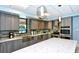 Well-appointed kitchen with stainless steel appliances, tile backsplash, and island at 2045 Gulf Of Mexico Dr # M1-207, Longboat Key, FL 34228