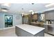 Modern kitchen featuring stainless steel appliances, stone countertops, and a center island at 2045 Gulf Of Mexico Dr # M1-207, Longboat Key, FL 34228
