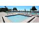 Inviting pool area with numerous lounge chairs, offering a perfect spot for relaxation and enjoyment in a sunny outdoor setting at 2045 Gulf Of Mexico Dr # 207, Longboat Key, FL 34228