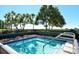 Inviting pool area with lush tropical landscaping, offering a tranquil outdoor space at 2045 Gulf Of Mexico Dr # 207, Longboat Key, FL 34228