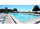 Beautiful pool surrounded by lounge chairs and umbrellas, offering a relaxing oasis with stunning views of lush greenery at 2045 Gulf Of Mexico Dr # M1-207, Longboat Key, FL 34228