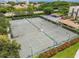 Overhead image of multiple tennis courts and parking with tropical landscaping at 2045 Gulf Of Mexico Dr # M1-207, Longboat Key, FL 34228