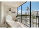 Relaxing balcony features tile floors, a lounger, and nice views of the beach and tropical foliage at 2045 Gulf Of Mexico Dr # M1-207, Longboat Key, FL 34228