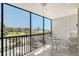 Relaxing balcony offers views of the beach, lush landscaping, and parking at 2045 Gulf Of Mexico Dr # M1-207, Longboat Key, FL 34228