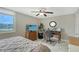 Relaxing bedroom featuring neutral walls, a ceiling fan, and a well-lit desk area with a view at 2045 Gulf Of Mexico Dr # M1-207, Longboat Key, FL 34228