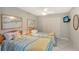 Bedroom featuring two twin beds, a ceiling fan, and a wall-mounted TV at 2045 Gulf Of Mexico Dr # M1-207, Longboat Key, FL 34228
