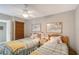 Bedroom featuring two twin beds, a ceiling fan, and natural window blinds at 2045 Gulf Of Mexico Dr # M1-207, Longboat Key, FL 34228