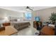 Comfortable bedroom features a ceiling fan, tile floors, and a convenient desk area with a view at 2045 Gulf Of Mexico Dr # M1-207, Longboat Key, FL 34228