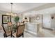 Dining room with a modern chandelier and a view of the kitchen at 2045 Gulf Of Mexico Dr # M1-207, Longboat Key, FL 34228