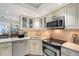 Well-equipped kitchen with stainless steel appliances and ample counter space at 2045 Gulf Of Mexico Dr # M1-207, Longboat Key, FL 34228