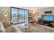 Cozy living room with a sliding glass door that opens to an outdoor patio at 2045 Gulf Of Mexico Dr # M1-207, Longboat Key, FL 34228
