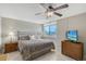 Calm main bedroom with a ceiling fan and a window view at 2045 Gulf Of Mexico Dr # M1-207, Longboat Key, FL 34228