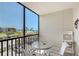 Outdoor patio with seating and a view of the beach and ocean at 2045 Gulf Of Mexico Dr # M1-207, Longboat Key, FL 34228