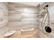 Shower stall featuring white tile with marble accents, a handheld shower head, and safety bar at 2045 Gulf Of Mexico Dr # M1-207, Longboat Key, FL 34228