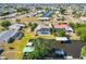 Aerial view of a home on a canal with a boat lift, neighboring homes, and a partial view of the surrounding neighborhood at 21152 Higgs Dr, Port Charlotte, FL 33952