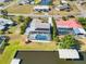 Aerial view of the home showing the front yard, backyard pool, and driveway at 21152 Higgs Dr, Port Charlotte, FL 33952