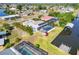 An aerial view of a waterfront property with a screened-in pool and a boat dock providing direct access to the water at 21152 Higgs Dr, Port Charlotte, FL 33952