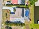 An aerial perspective of a home featuring a pool enclosure and tasteful landscaping, perfect for outdoor enjoyment at 21152 Higgs Dr, Port Charlotte, FL 33952