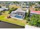 Aerial view showing the home's enclosed pool and waterfront access at 21152 Higgs Dr, Port Charlotte, FL 33952