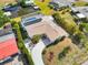 Aerial view showcasing a well-maintained home with a pool, lush landscaping, and a long driveway at 21152 Higgs Dr, Port Charlotte, FL 33952