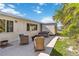A cozy backyard with seating area and fire pit near a storage shed surrounded by lush greenery at 21152 Higgs Dr, Port Charlotte, FL 33952