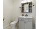 Compact bathroom featuring a neutral vanity with a mirror and a toilet at 21152 Higgs Dr, Port Charlotte, FL 33952