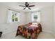 Well-lit bedroom featuring neutral walls, ceiling fan and multiple windows at 21152 Higgs Dr, Port Charlotte, FL 33952