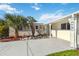 Charming single-story home featuring white exterior, decorative pillars, xeriscaping, and well-maintained landscaping at 21152 Higgs Dr, Port Charlotte, FL 33952