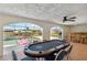 A poker table sits in a game room with access to the pool and an outdoor bar at 21152 Higgs Dr, Port Charlotte, FL 33952