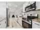 Modern kitchen with stainless steel appliances, granite countertops, and ample cabinet space at 21152 Higgs Dr, Port Charlotte, FL 33952
