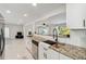 Bright, updated kitchen with granite countertops, stainless steel appliances, and modern finishes at 21152 Higgs Dr, Port Charlotte, FL 33952