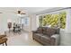 Bright living room with lots of windows, comfortable seating, and seamless connection to the dining area at 21152 Higgs Dr, Port Charlotte, FL 33952
