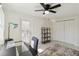 Bright office space featuring ceiling fan, neutral walls and shelving at 21152 Higgs Dr, Port Charlotte, FL 33952