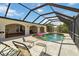 A screened-in pool and sun loungers provide a resort-like atmosphere at 21152 Higgs Dr, Port Charlotte, FL 33952