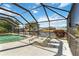 A relaxing waterfront view from the screened-in pool deck with inviting sun loungers at 21152 Higgs Dr, Port Charlotte, FL 33952
