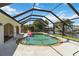A beautiful screened-in pool with an inflatable flamingo floats in the crystal clear water at 21152 Higgs Dr, Port Charlotte, FL 33952