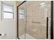 Stylish shower with framed glass doors and textured shower surround with built-in shelves at 21152 Higgs Dr, Port Charlotte, FL 33952